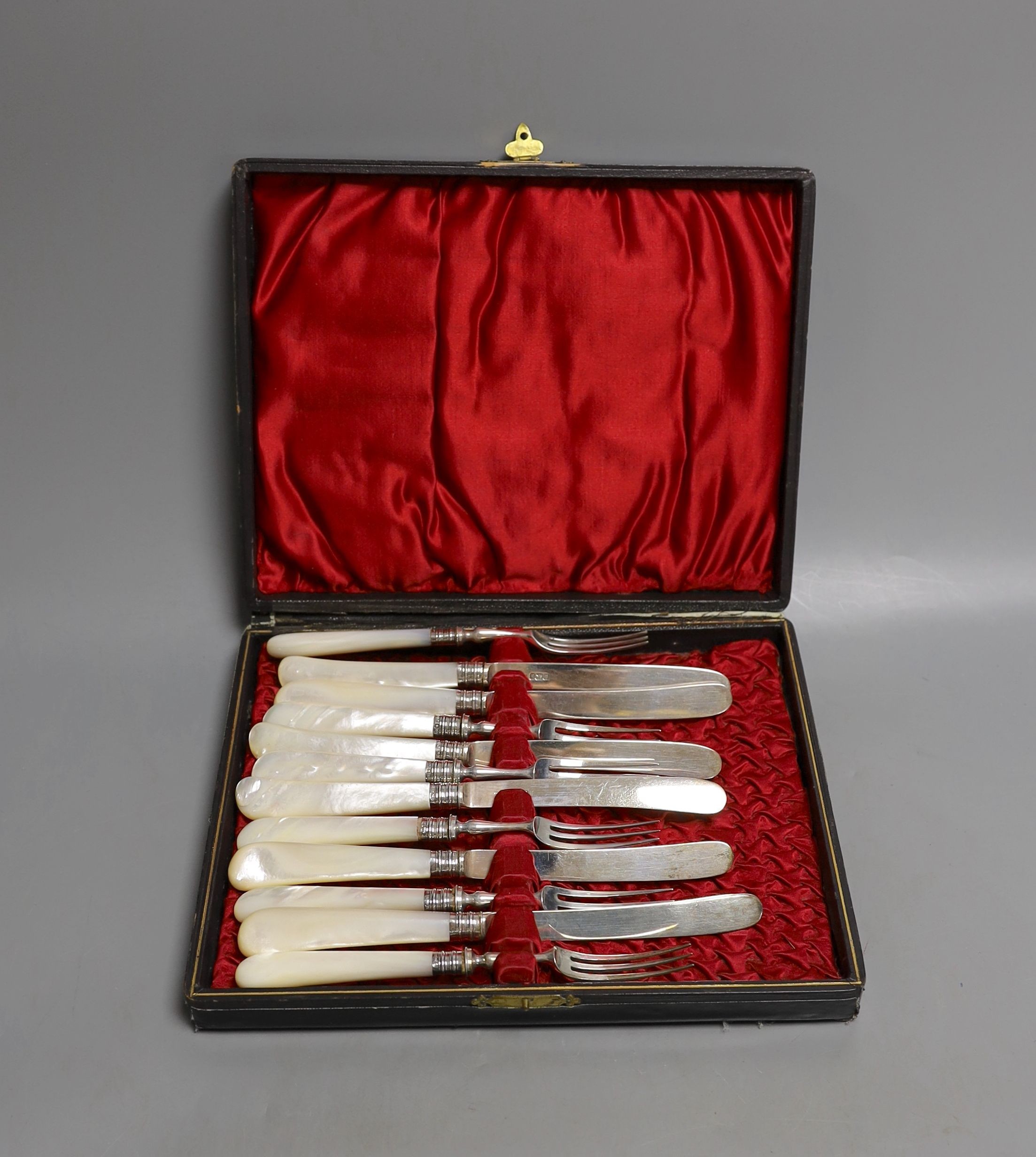 A cased set of six pairs of Edwardian mother of pearl handled silver dessert eaters, Sheffield, 1902.
